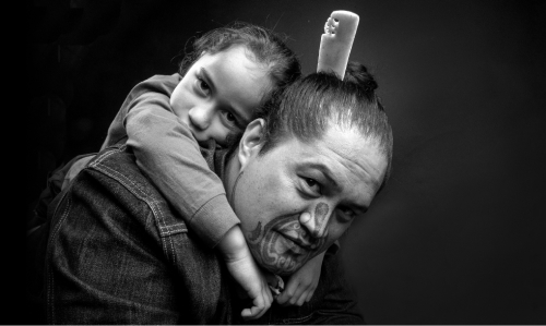 Reweti Arapere carries his son Taupounamu on his shoulders